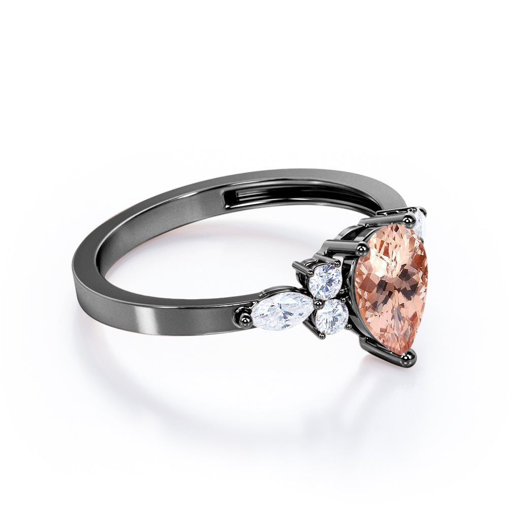 Classic 7 stone 1.25 carat Pear shaped Morganite and diamond marquise and dot engagement ring in Black gold