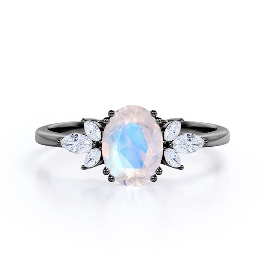 Floral inspired 1.25 carat Oval cut Rainbow Moonstone and marquise diamond double prong engagement ring in Black gold