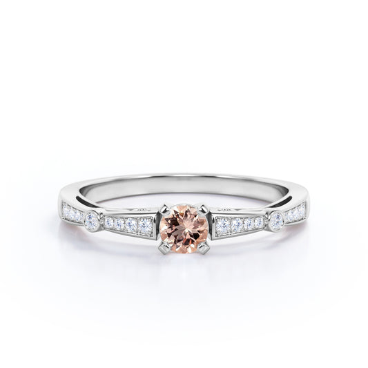 Prong style 0.75 carat Round cut Peach Pink Morganite and diamond tapered baguette engagement ring in White gold