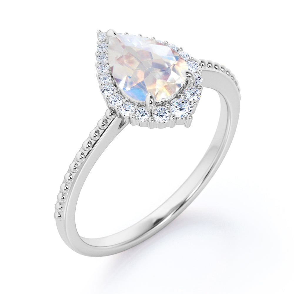 Royal themed 1.3 carat Pear Moonstone and diamond Milgrain and halo engagement ring in White gold