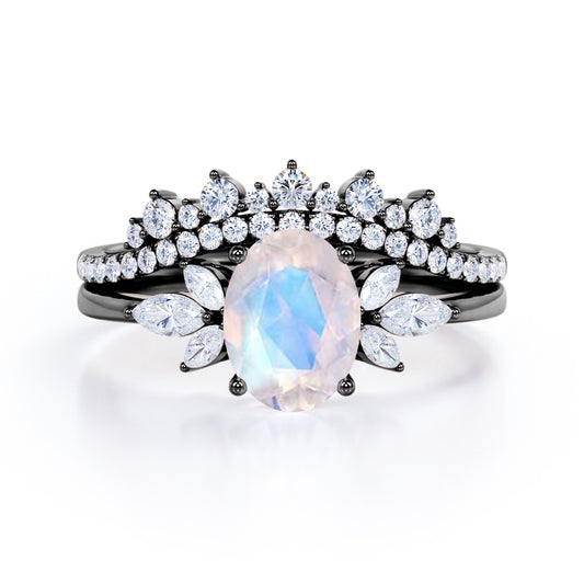 Garland Inspired 1.65 carat Oval shaped Blue Moonstone and diamond contoured seven stone Bridal set in Black gold