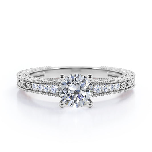 Artistic filigree 1.1 carat Moissanite and diamond low-basket setting engagement ring in White gold