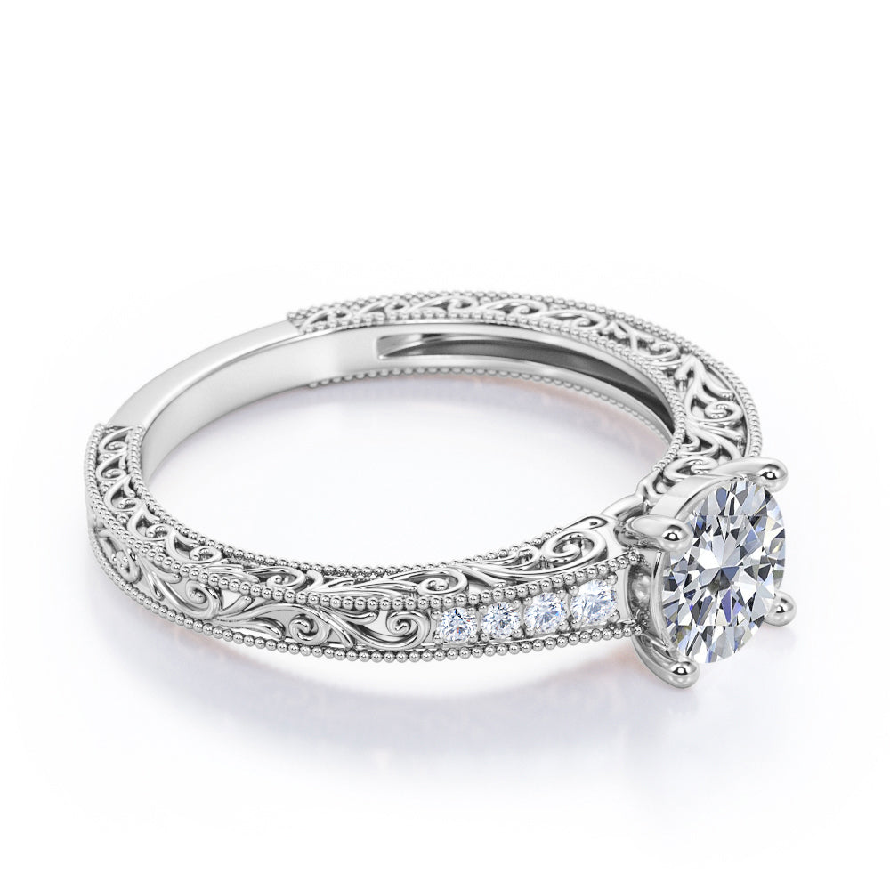 Artistic filigree 1.1 carat Moissanite and diamond low-basket setting engagement ring in White gold
