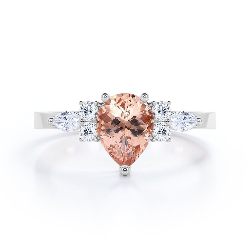 Classic 7 stone 1.25 carat Pear shaped Morganite and diamond marquise and dot engagement ring in Black gold