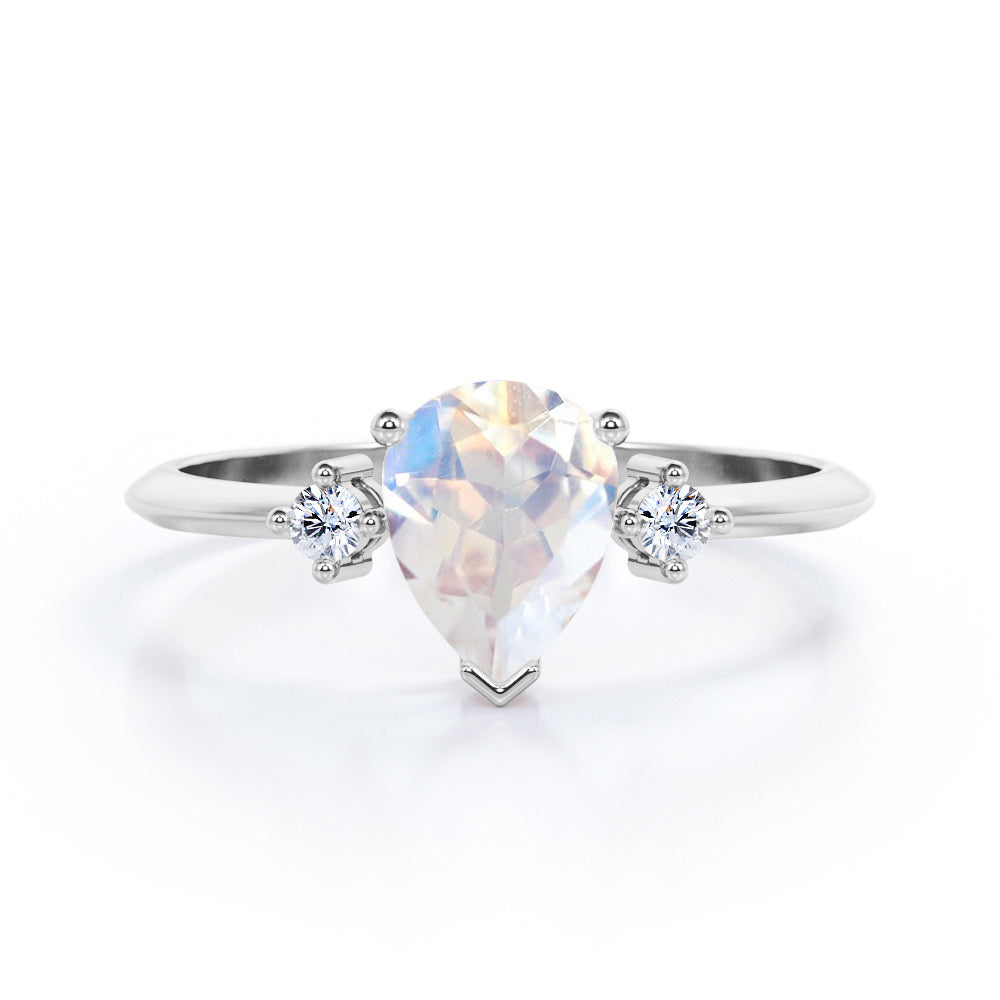 Stylish 1.1 carat Pear Cut Blue Moonstone and diamond trilogy engagement ring in Rose gold