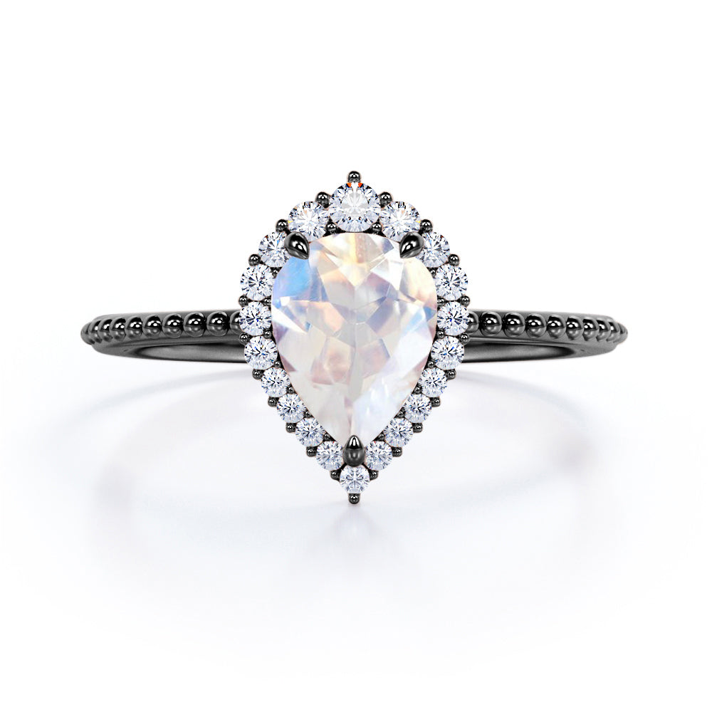 Royal themed 1.3 carat Pear Moonstone and diamond Milgrain and halo engagement ring in White gold