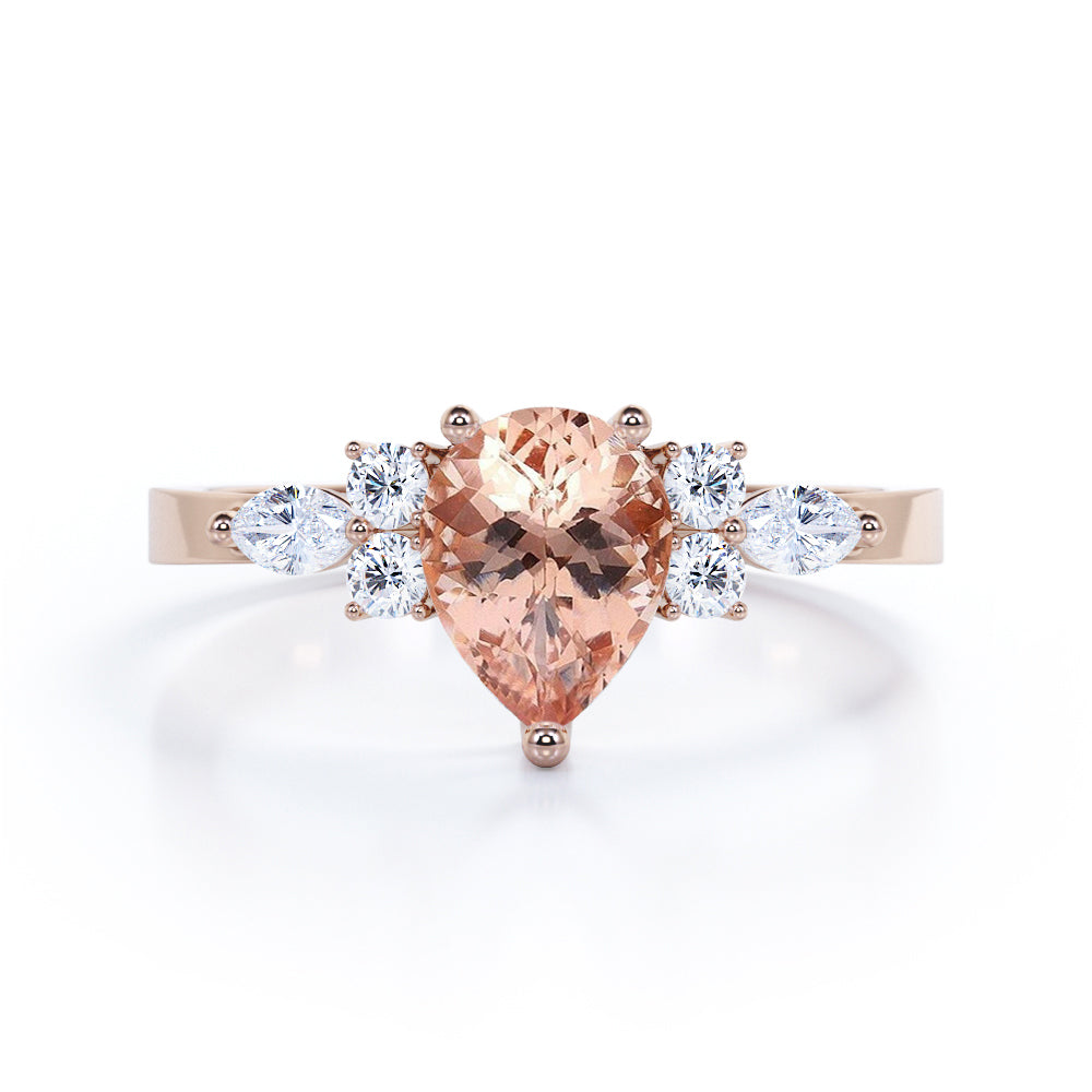 Classic 7 stone 1.25 carat Pear shaped Morganite and diamond marquise and dot engagement ring in Black gold