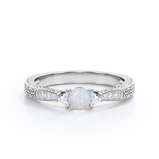 Contemporary style Filigree 0.75 carat Round cut Ethiopian Opal and diamond triangle engagement ring for her