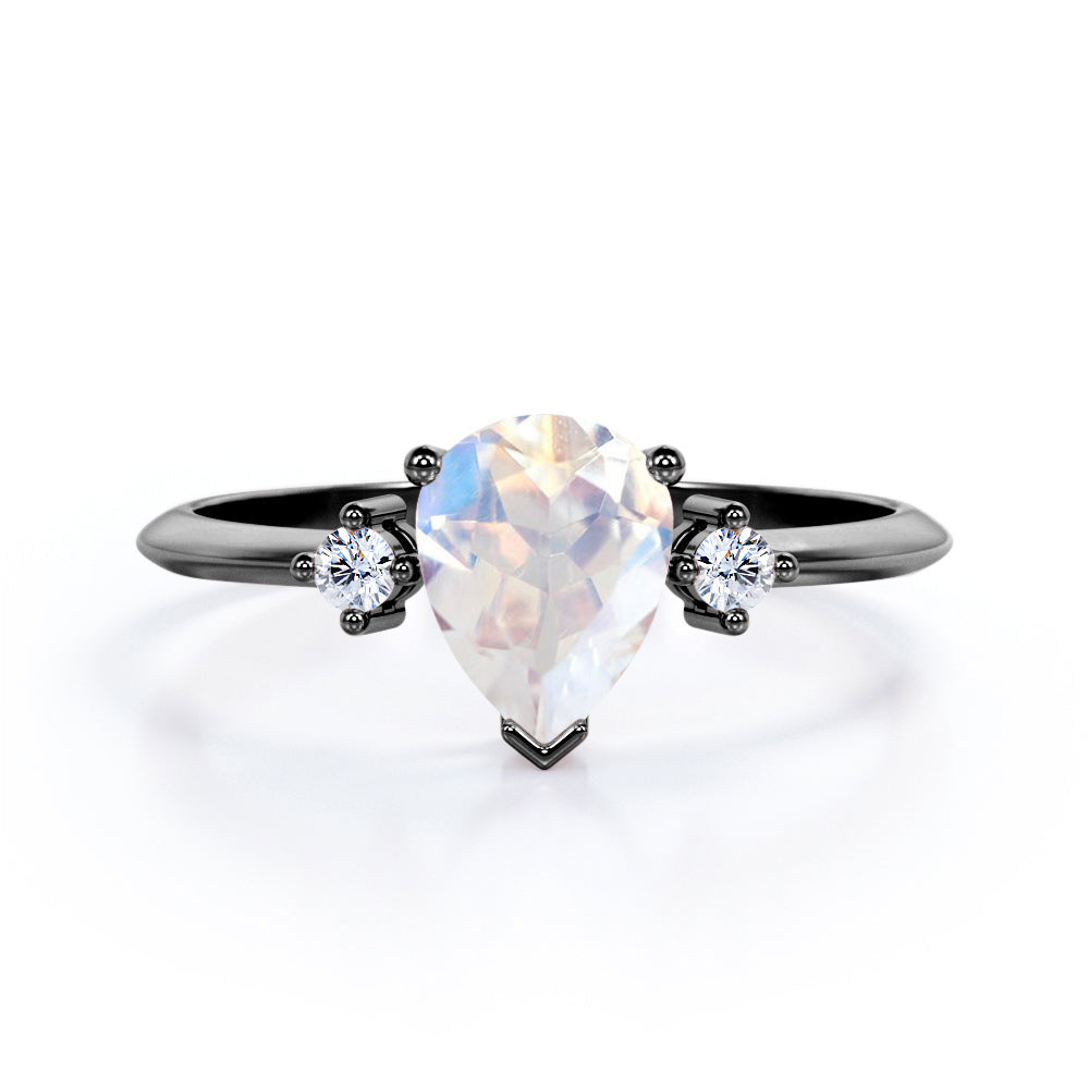 Stylish 1.1 carat Pear Cut Blue Moonstone and diamond trilogy engagement ring in Rose gold