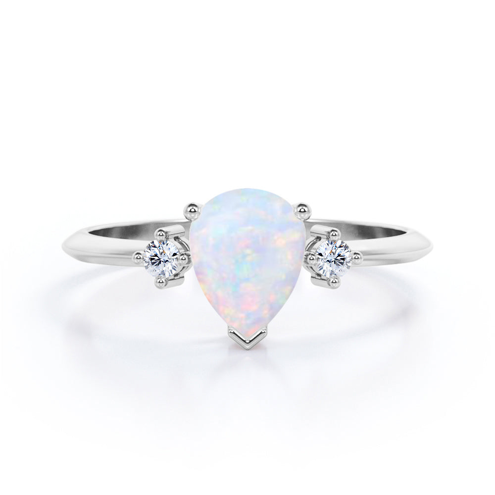 Elegant Three stone 1.10 carat Tear drop shape Ethiopian Opal and diamond pinched shank engagement ring in Black gold