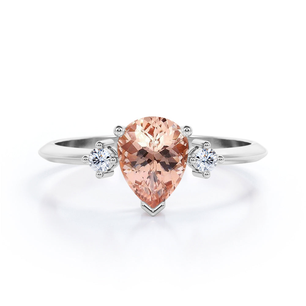 Three prong setting 1.1 carat Pear shaped Morganite and diamond trilogy anniversary ring for women in Black gold