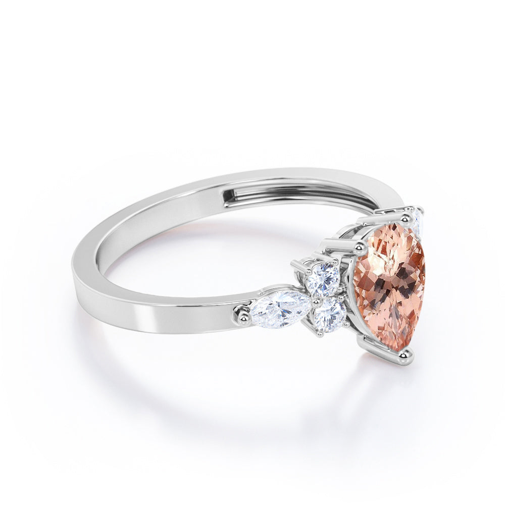 Classic 7 stone 1.25 carat Pear shaped Morganite and diamond marquise and dot engagement ring in Black gold