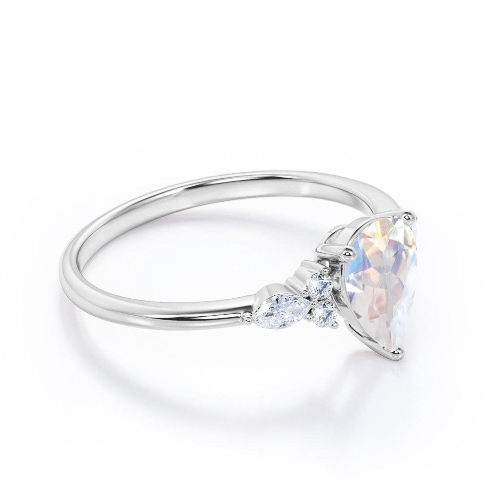 Art Deco inspired 1.2 carat Pear shaped Moonstone and diamond multistone engagement ring in Rose gold