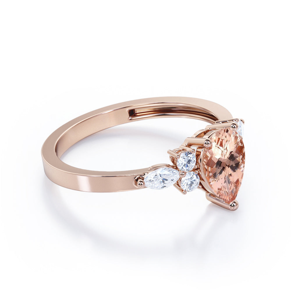 Classic 7 stone 1.25 carat Pear shaped Morganite and diamond marquise and dot engagement ring in Black gold