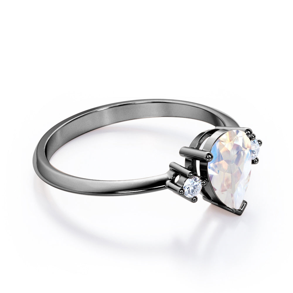 Stylish 1.1 carat Pear Cut Blue Moonstone and diamond trilogy engagement ring in Rose gold