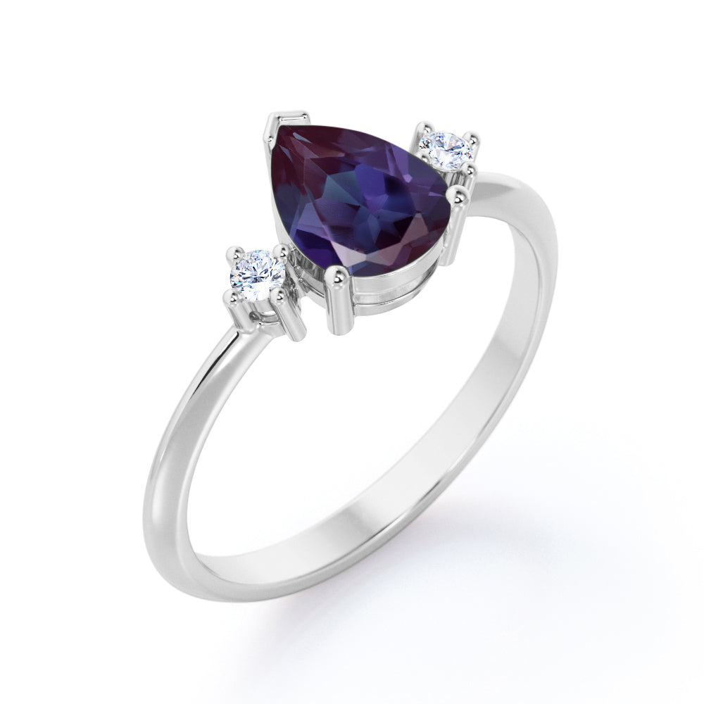 Classic three stone 1.1 carat Pear shaped Alexandrite and diamond pinched shank engagement ring for women in Black gold