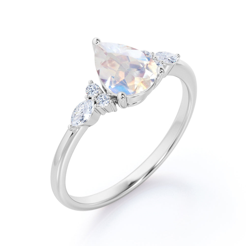 Art Deco inspired 1.2 carat Pear shaped Moonstone and diamond multistone engagement ring in Rose gold