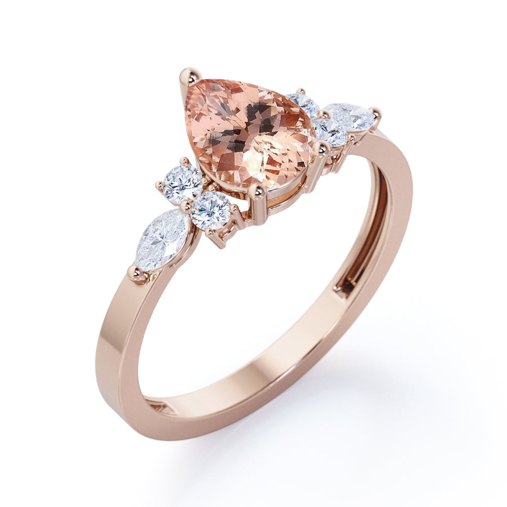 Classic 7 stone 1.25 carat Pear shaped Morganite and diamond marquise and dot engagement ring in Black gold