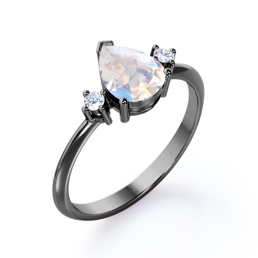 Stylish 1.1 carat Pear Cut Blue Moonstone and diamond trilogy engagement ring in Rose gold