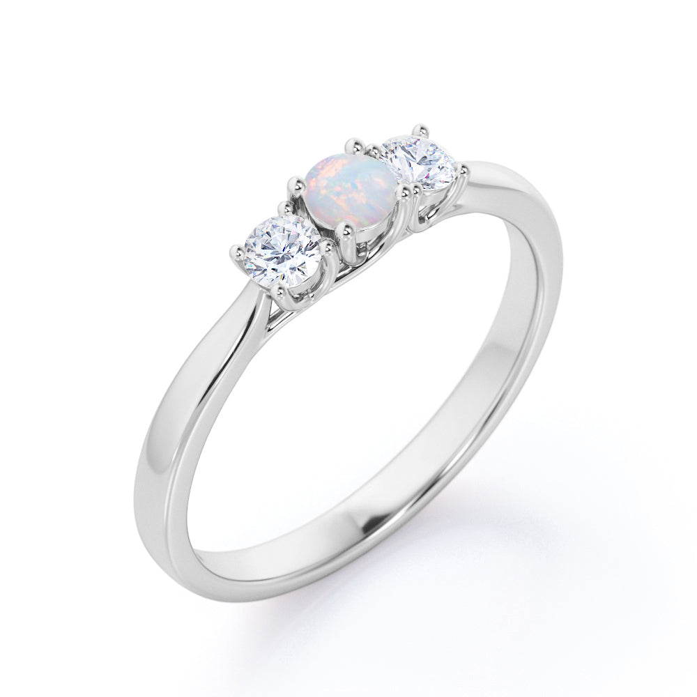 Tapered Shank 0.7 carat Round cut Ethiopian Opal and diamond triple stone engagement ring in Rose gold