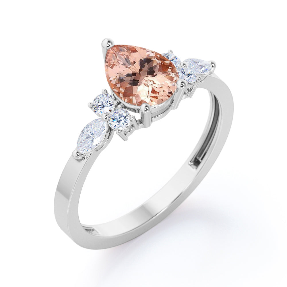 Classic 7 stone 1.25 carat Pear shaped Morganite and diamond marquise and dot engagement ring in Black gold