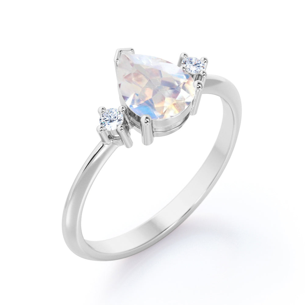 Stylish 1.1 carat Pear Cut Blue Moonstone and diamond trilogy engagement ring in Rose gold