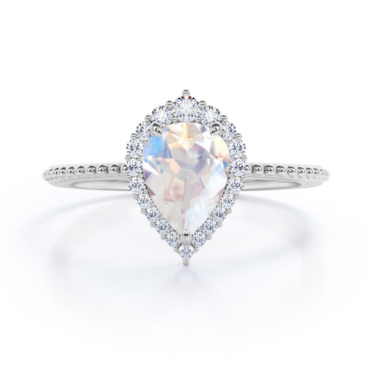 Royal themed 1.3 carat Pear Moonstone and diamond Milgrain and halo engagement ring in White gold