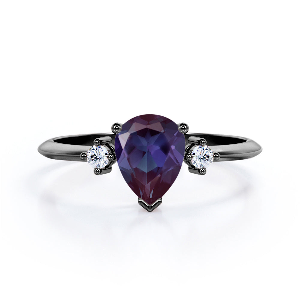 Classic three stone 1.1 carat Pear shaped Alexandrite and diamond pinched shank engagement ring for women in Black gold