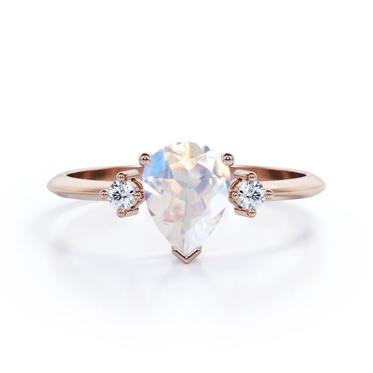Stylish 1.1 carat Pear Cut Blue Moonstone and diamond trilogy engagement ring in Rose gold