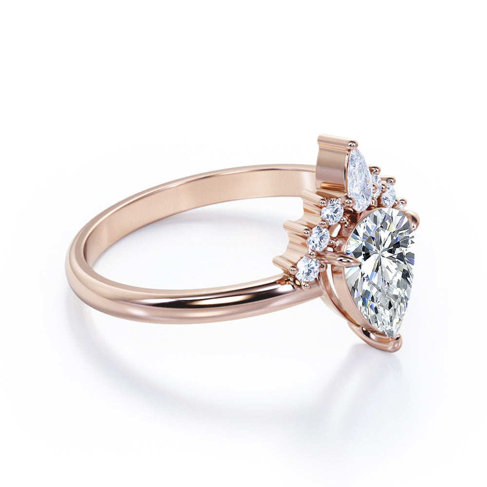 Chevron crown inspired 1.1 carat Pear shaped Moissanite and diamond engagement ring in Rose gold